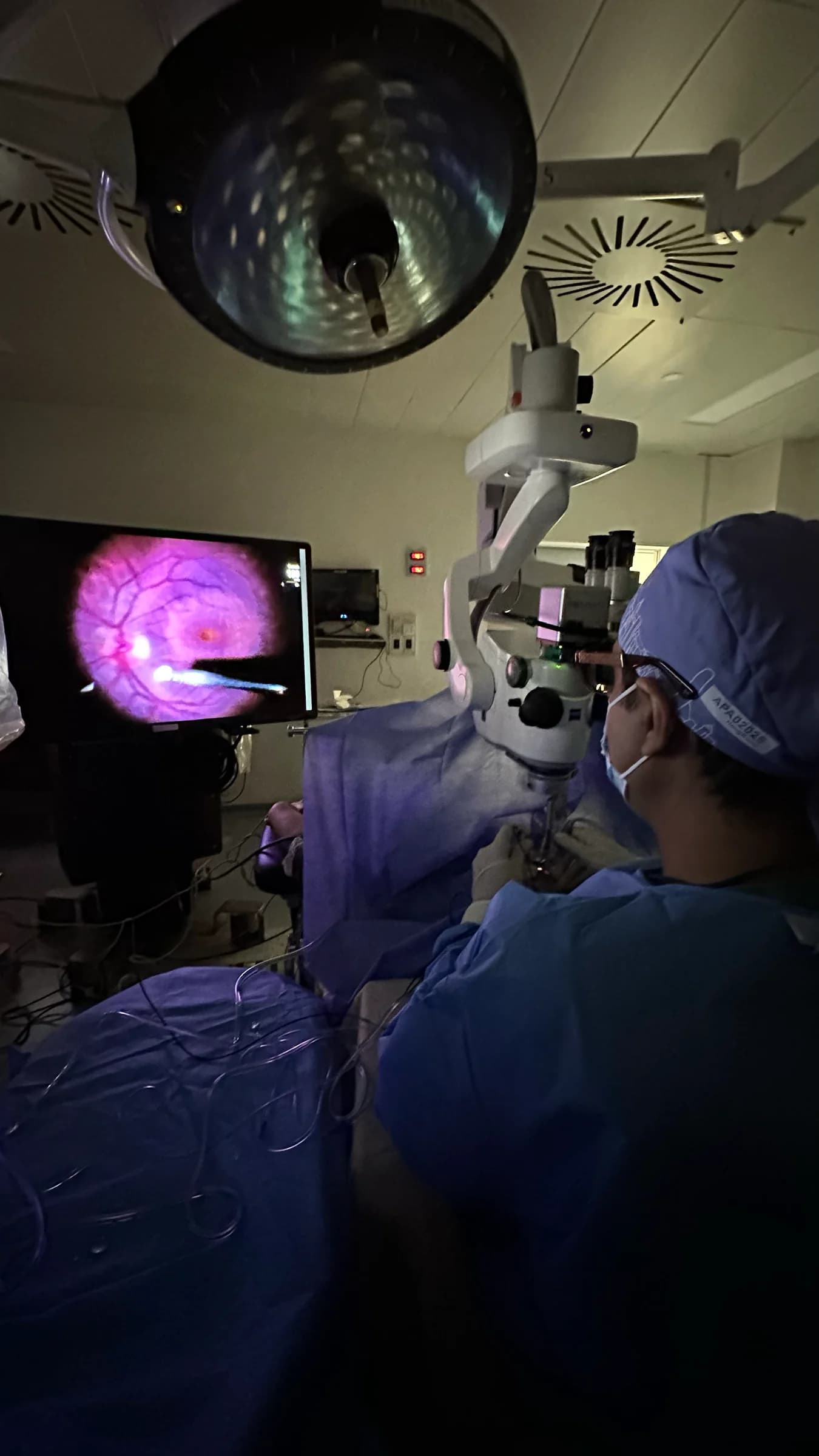 Prof. Dr. Amer Awan performing vitreoretinal surgery with a magnified retinal image on the operating monitor